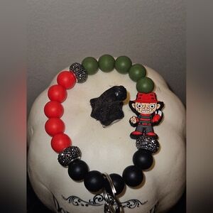 Red and Green Beaded Bracelet with Character Charm